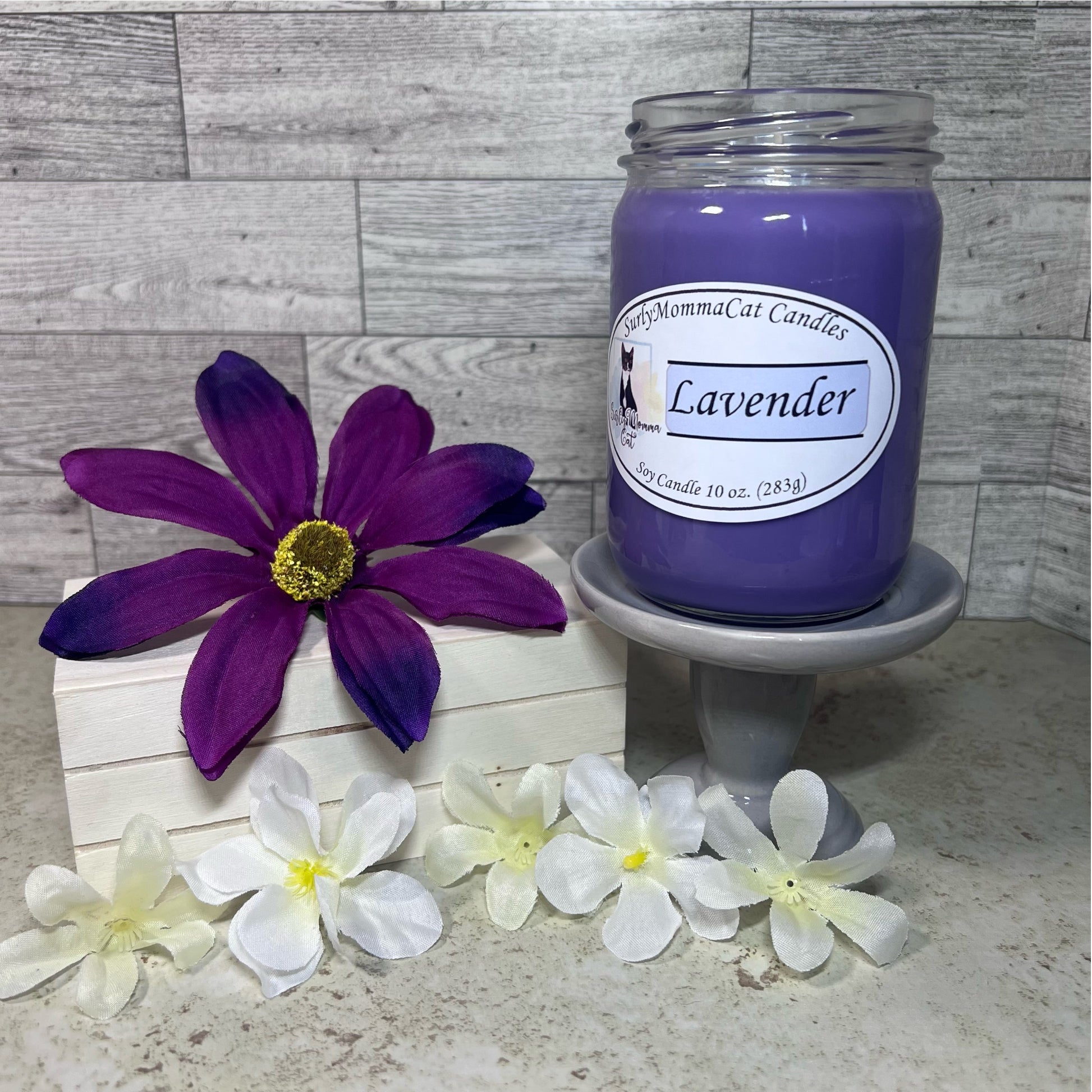 Purple Lavender Soy Glass Jar candle. Five white flowers and one purple flower for decoration.