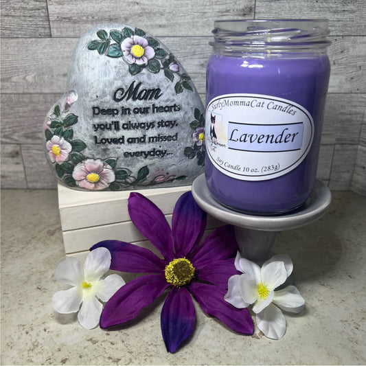 Purple Lavender Soy Glass Jar candle. A decorative stone that says"Mom Deep in our hearts you'll always stay. Loved and missed everyday..." Two white flowers and one purple flower for decoration.