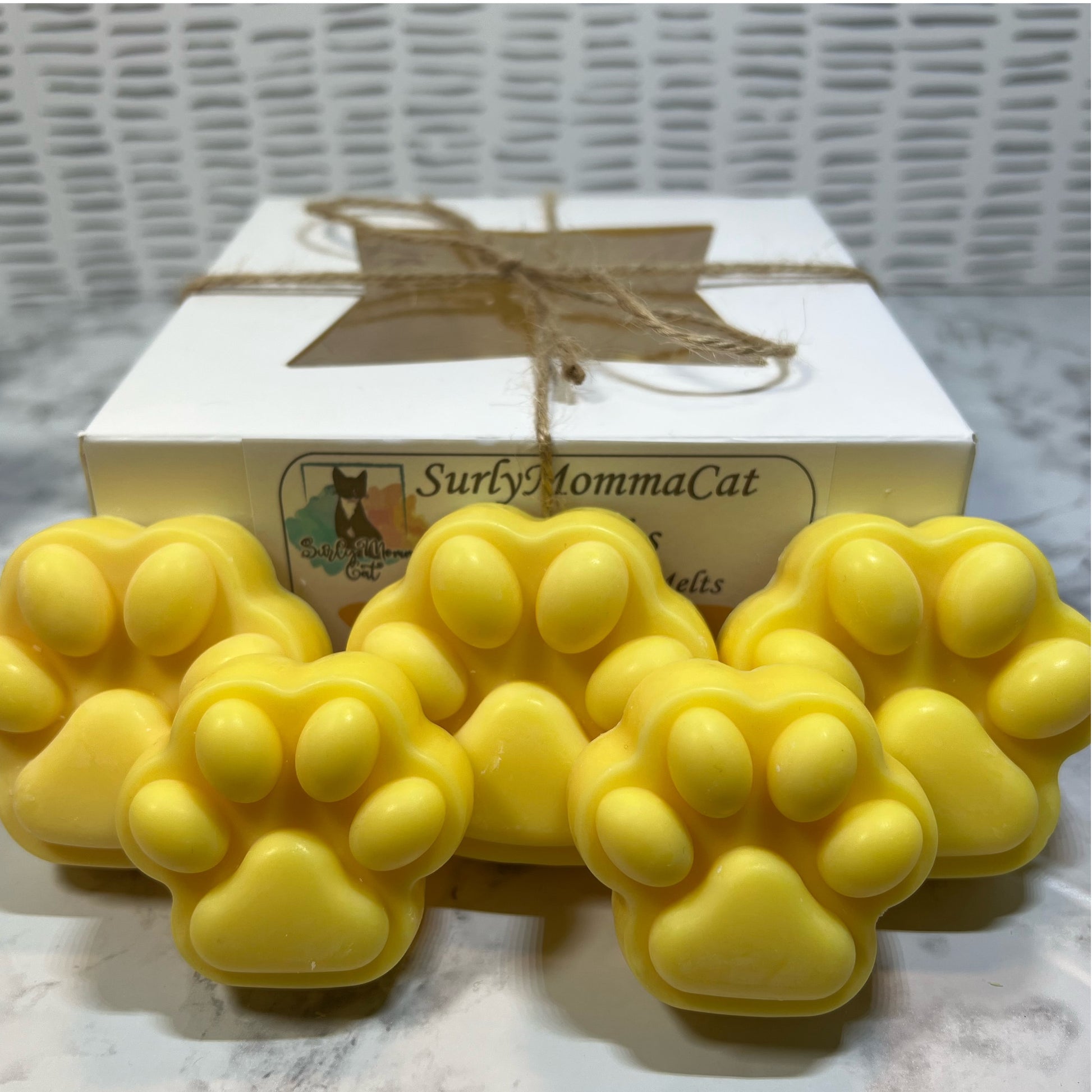 Five Yellow soy Margarita paw print wax melts with white box.