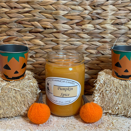 Orange Pumpkin Spice soy glass jar candle, with two small hay bale and two tin pumpkin pales with two small pumpkins for decoration.