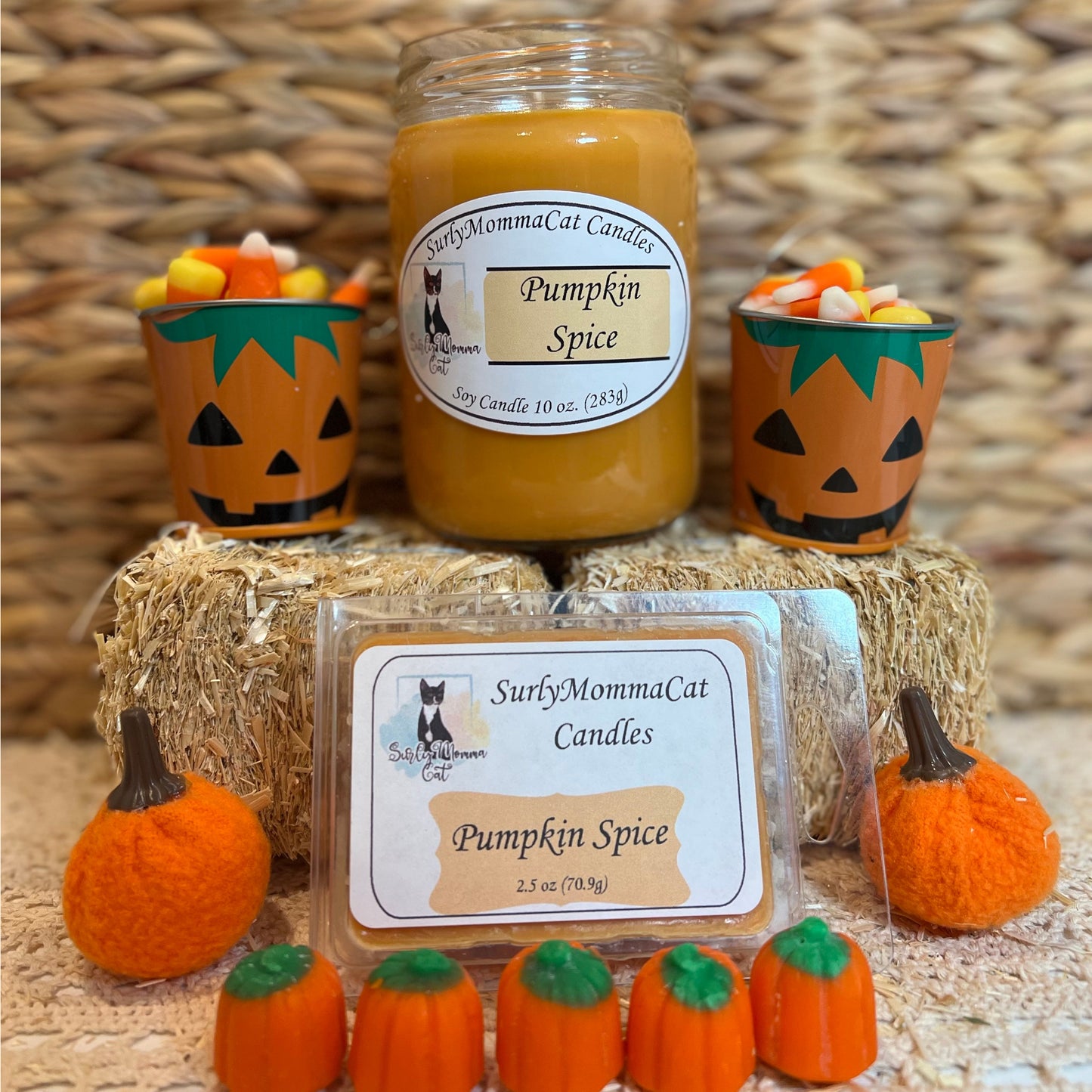 Orange Pumpkin Spice soy glass jar candle, with wax melt and two small pumpkin pails sitting on tiny decorative hay bales with candy corn pumpkins for decoration.